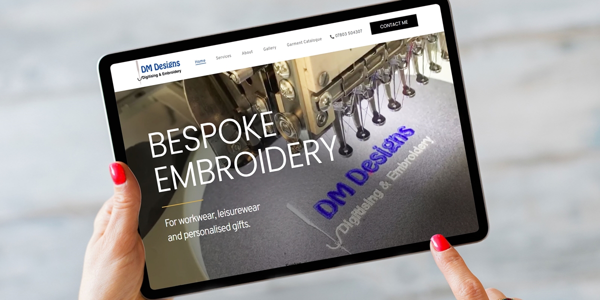DM Designs website on a tablet