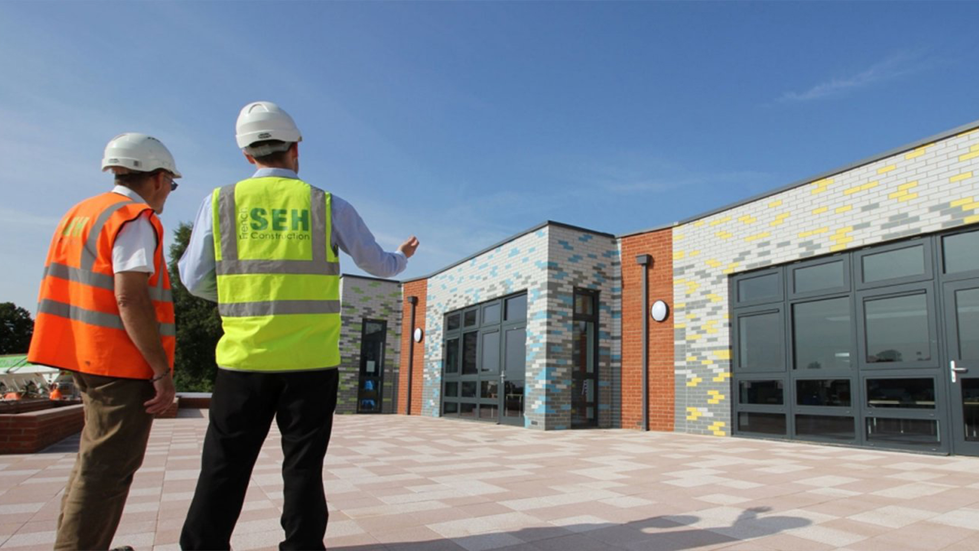 SEH French Case Study - Header image of workman presenting building