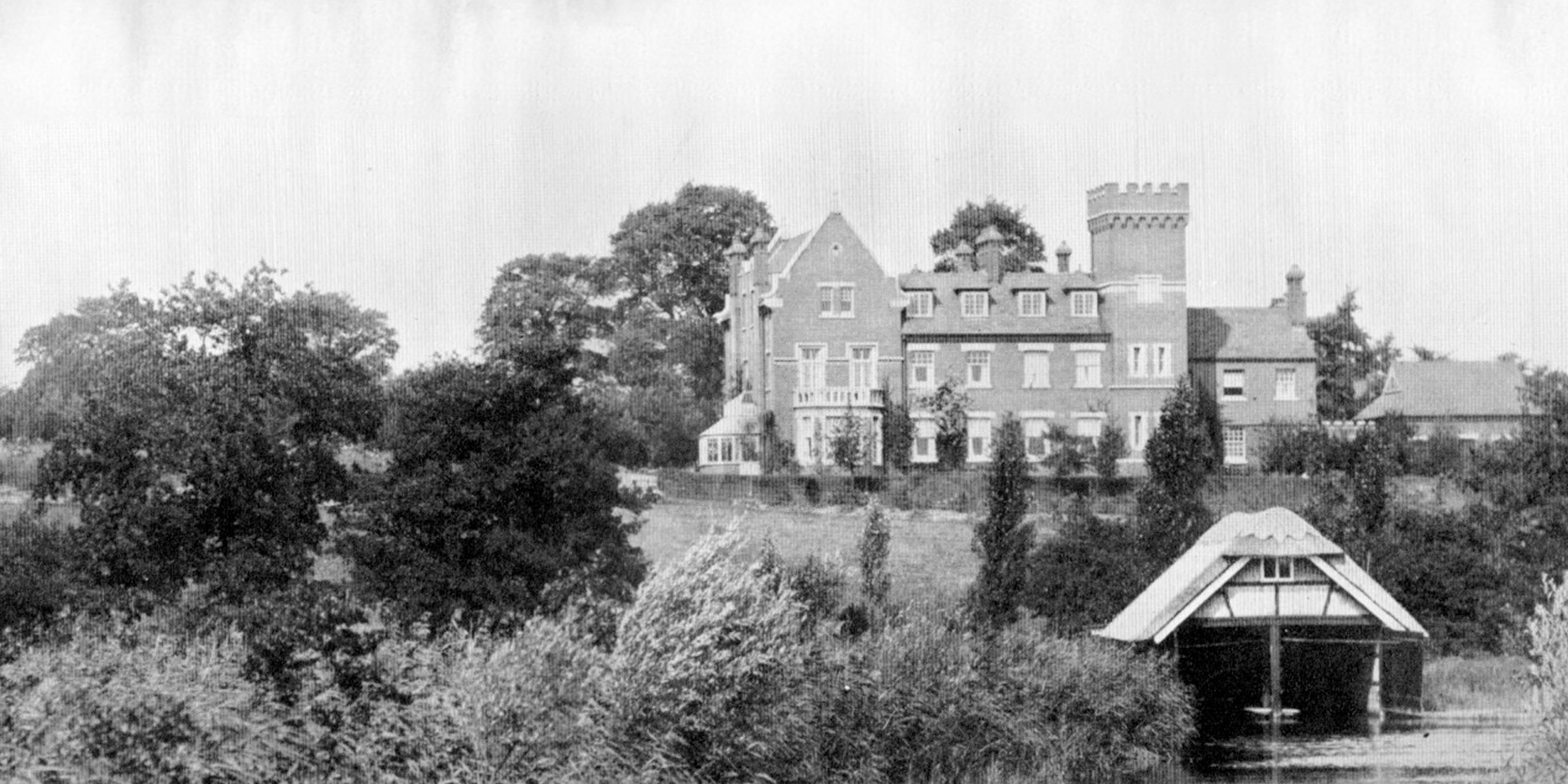 Old photo of Suffolk stately home with river and boat house